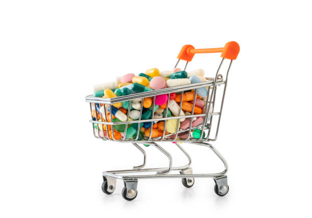 shopping cart filled with colorfull pills , isolated on white background