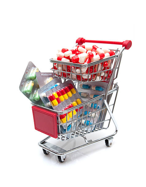 capsules in the shopping cart isolated on white.
